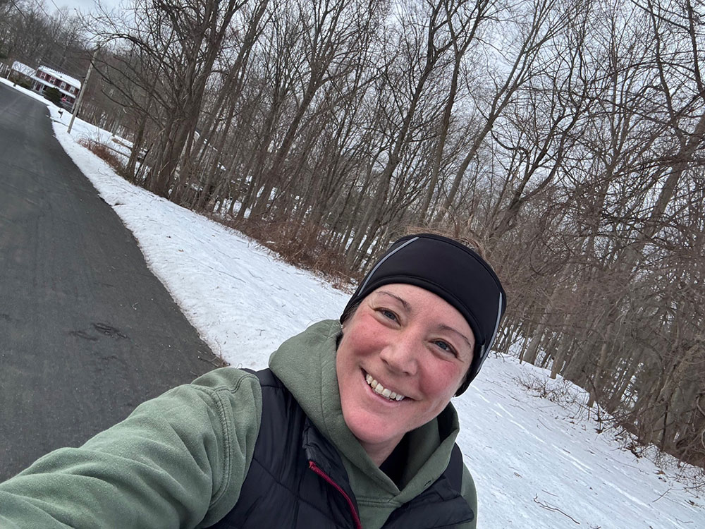 Megan Serke, wearing a beanie and jacket, takes a selfie in the snow.