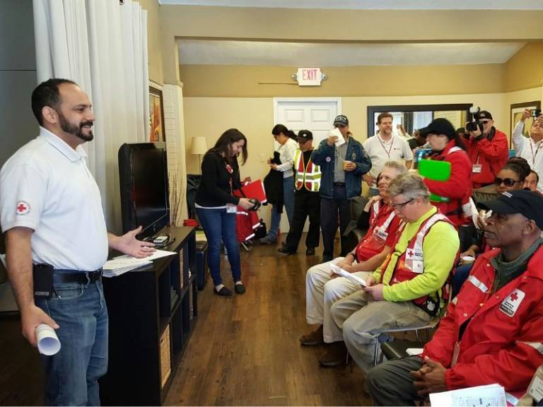 raul speaking to large group of volunteers
