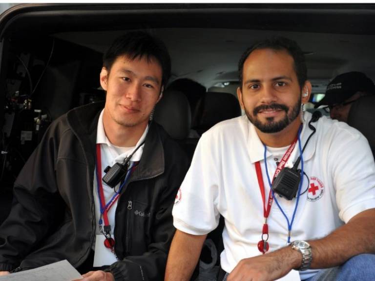 raul sitting with male volunteer in disaster response vehicle