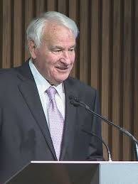 tom golisano speaking at podium