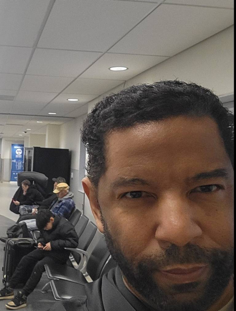 Selfie of man with people sitting behind him
