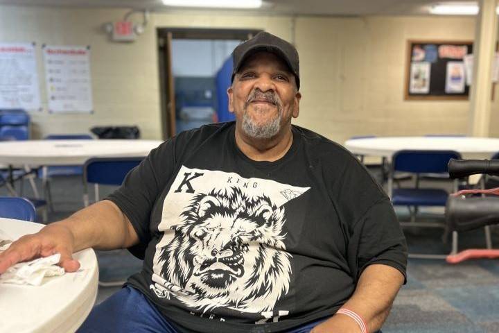 Man sits at table in Red Cross shelter