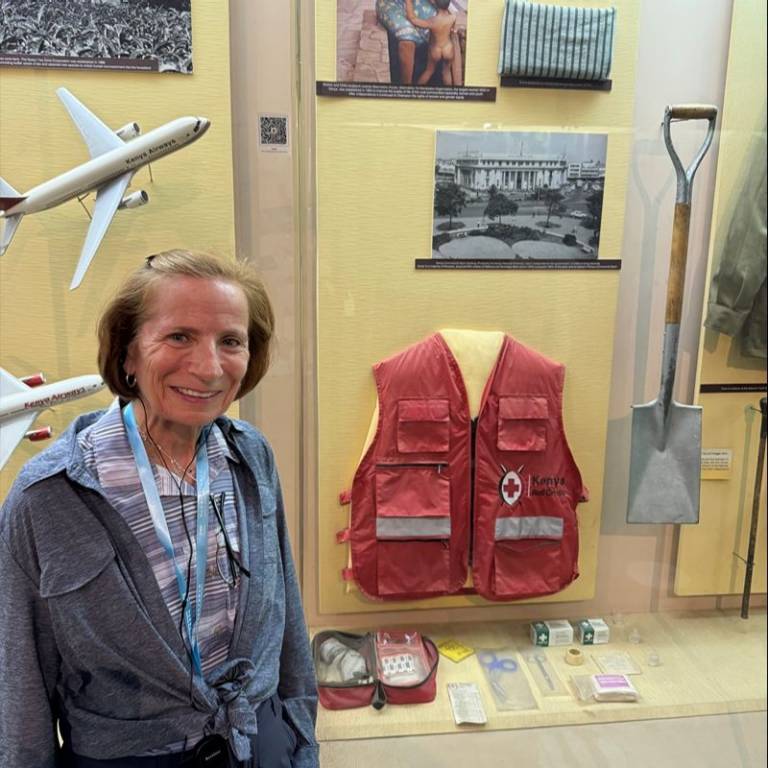 Sue next to a Red Cross exhibit.