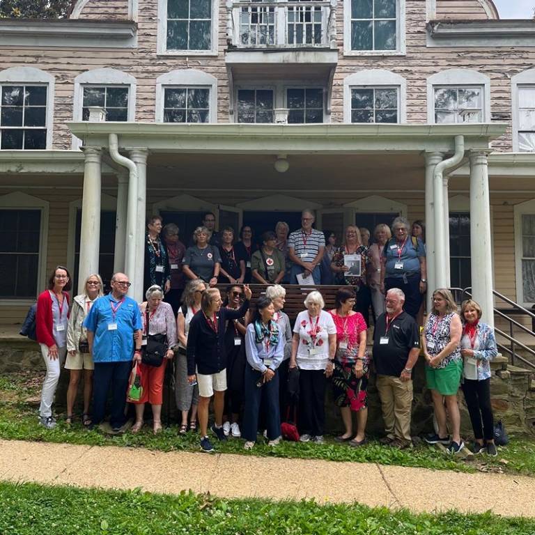 A group of people standing in front of a house