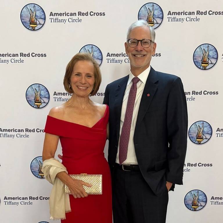 Sue at a gala next to a man.