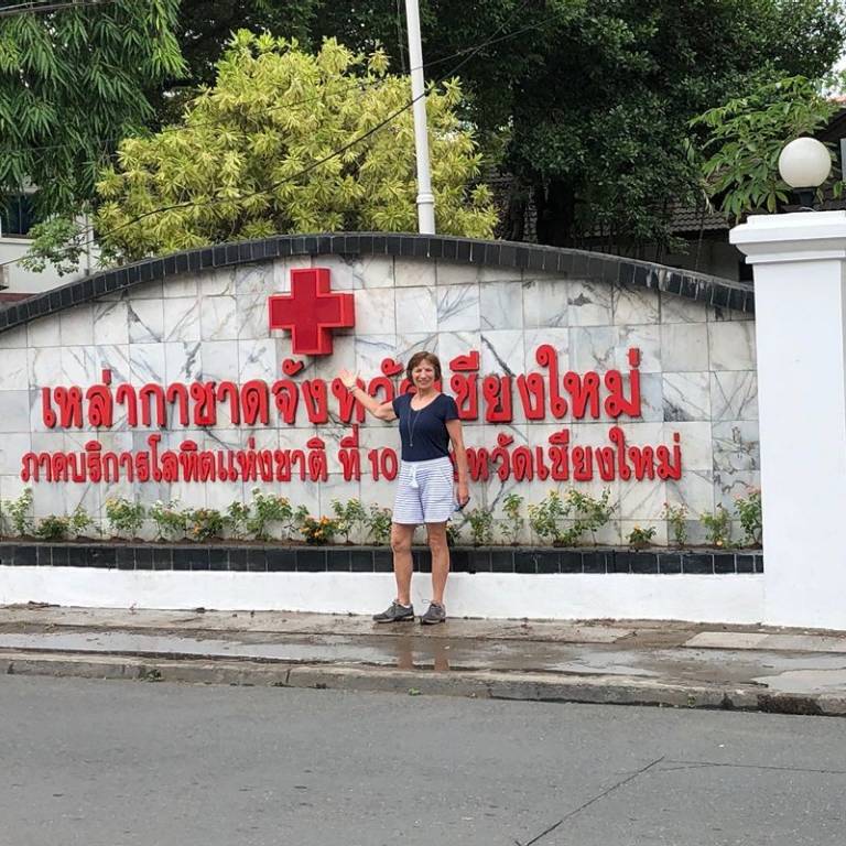 Sue standing in front of the Thialand INternatonal Red Cross building.