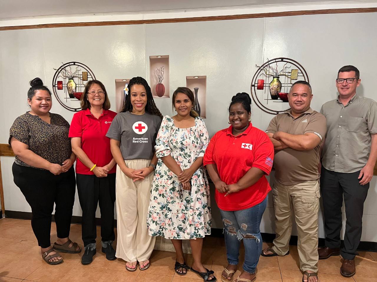 Group of people stand together in room
