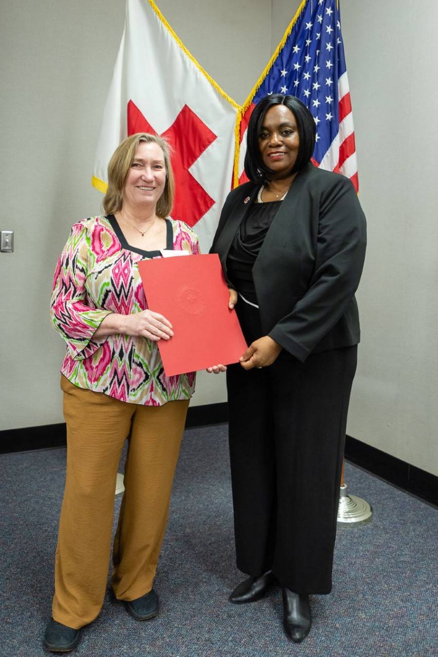Jayne Cabnet accepting award from red cross staff