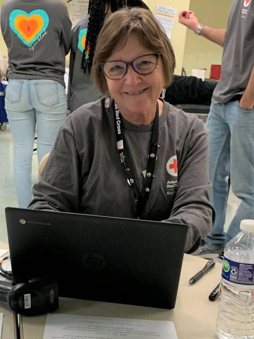 Kathleen Dykers smiling at a computer