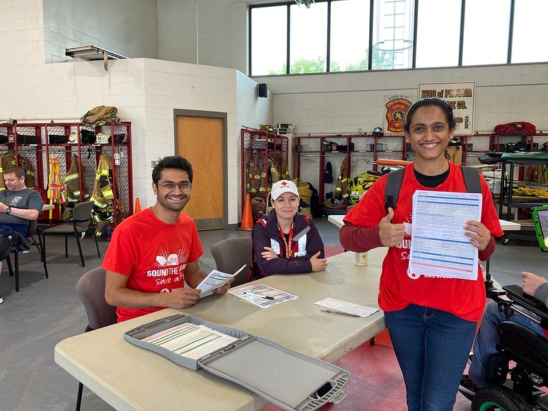 group of youth in red cross shirts