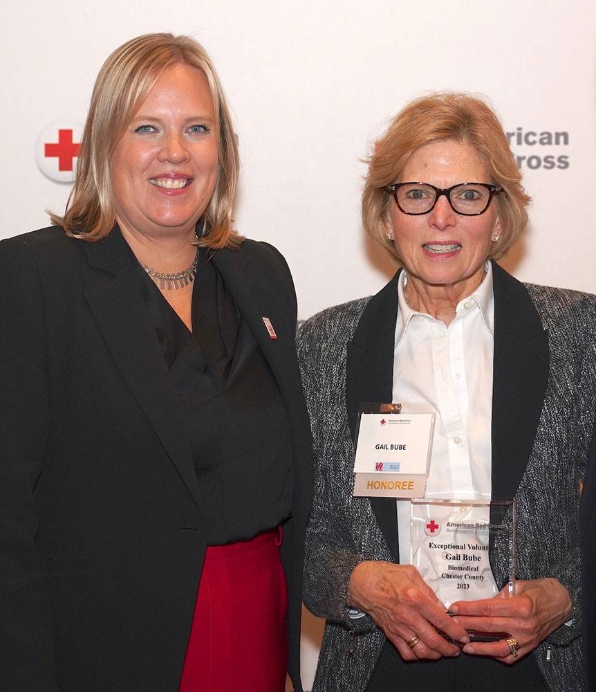 Gail Bube accepting award from red cross staff.