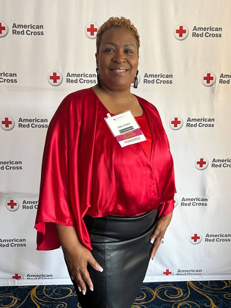 Lisa Stokes in evening wear with a Red Cross name tag on her blouse.