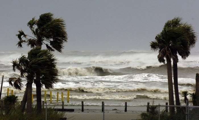 Waves crash on a shoreline before a hurricane