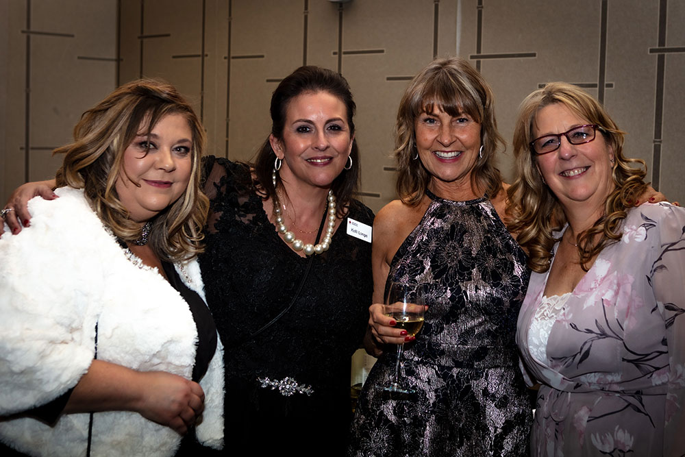 Four Red Cross Gala guests take a group photo.