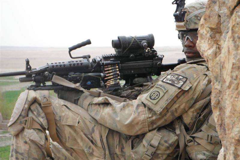 man in uniform holds weapon