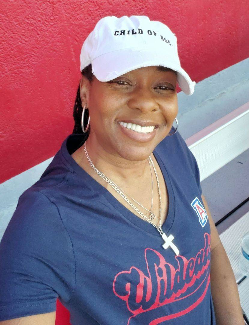 Akila takes selfie while wearing basebal cap