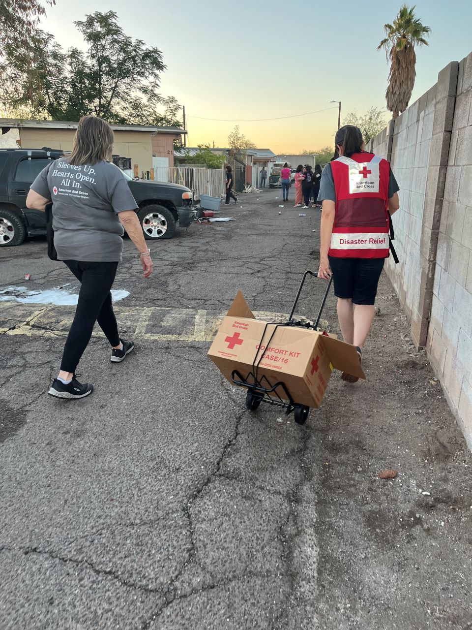 Two Red Cross volunteers pulling supplies