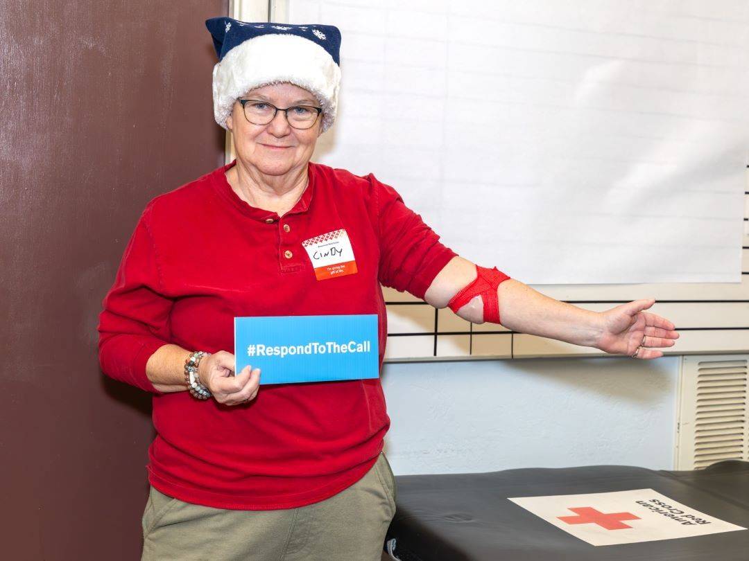 Woman proudly shows bandage after donating blood