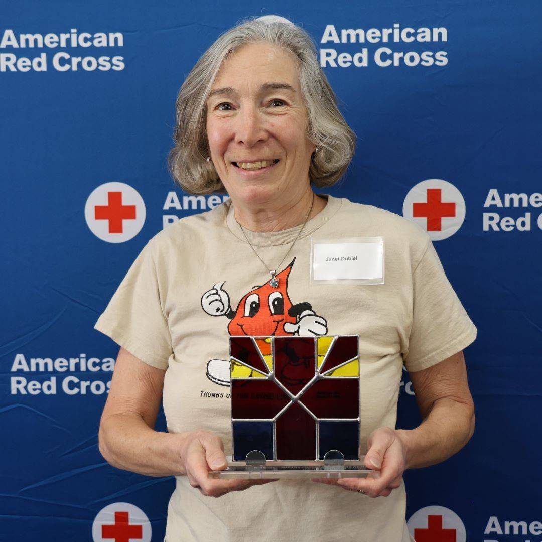 Janet holds Red Cross award