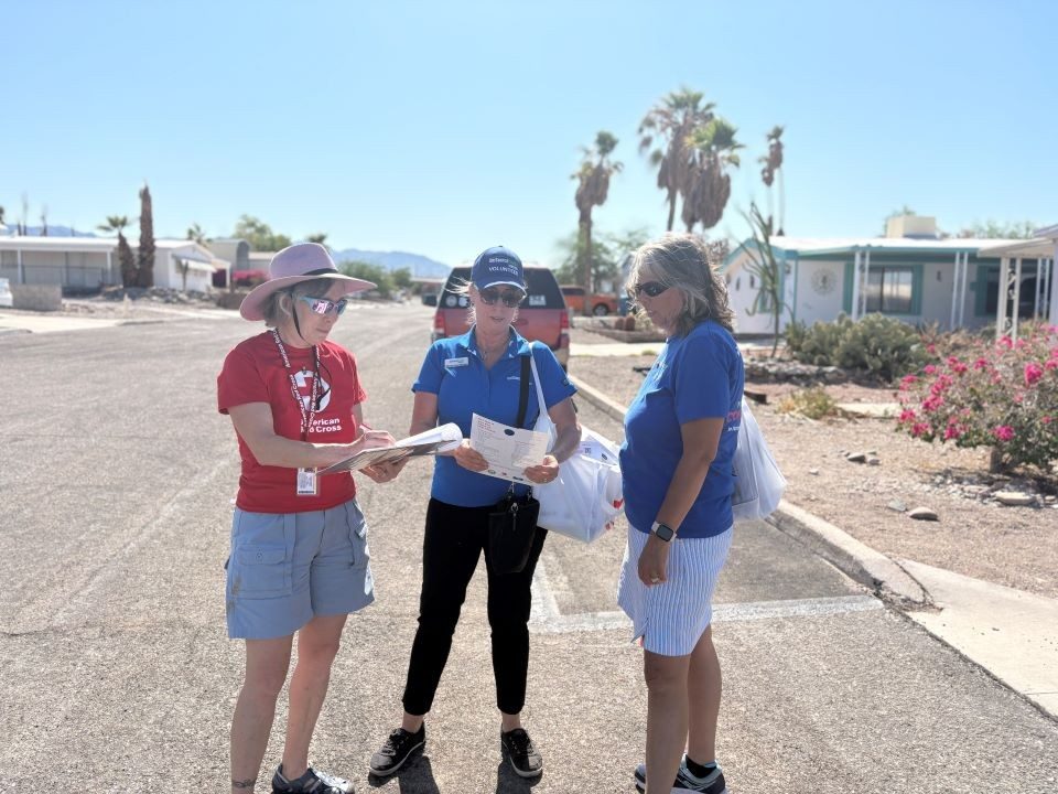 Three Red Cross volunteers talking to eachother.