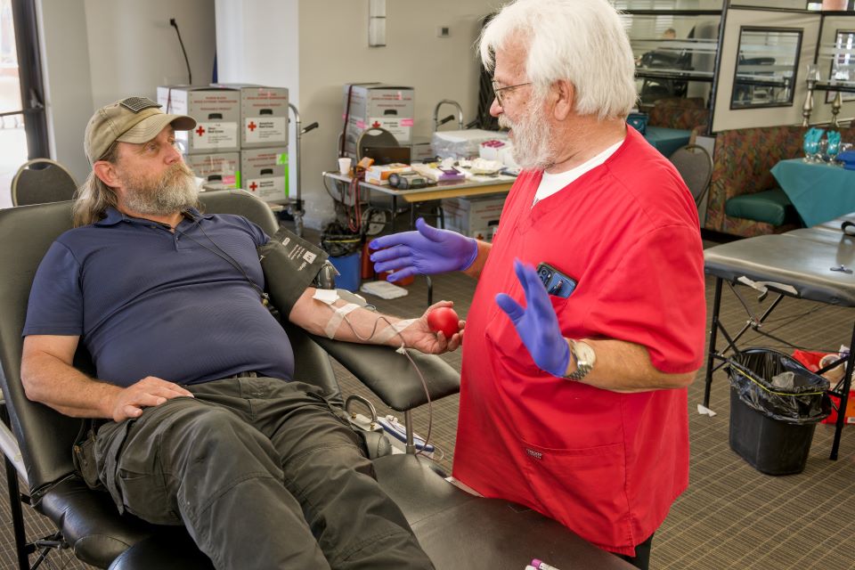 Person giving blood talking to a phlebotomist