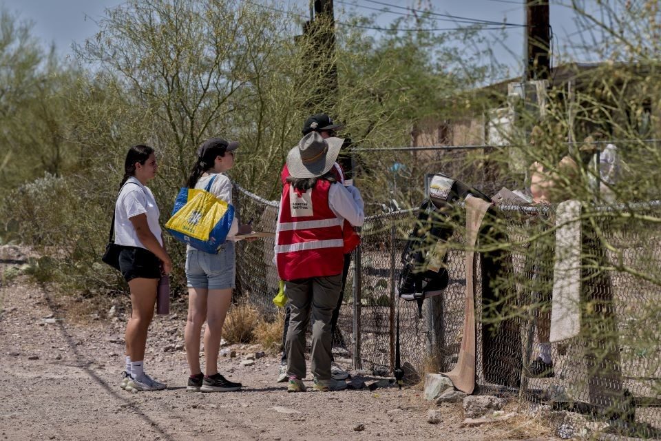 Group of Red Cross volunteers at a home.