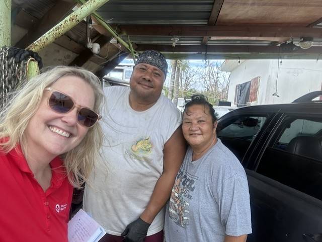 Lori Wilson takes selfie with two people behind her