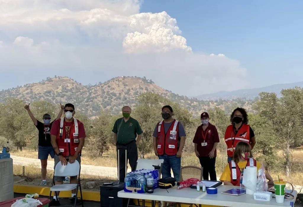 Group of Red Cross volunteers wear masks while standing outside