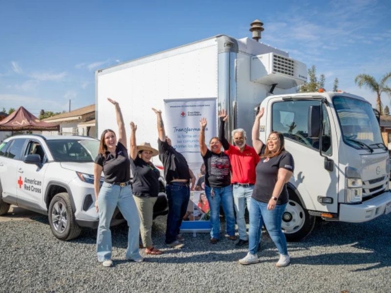 volunteers outside of truck and pop up banner