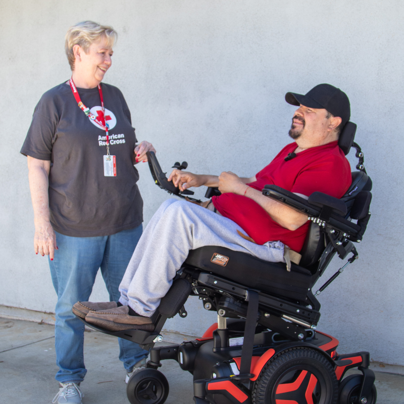 Ignacio in his wheelchair talking to Suzanne.
