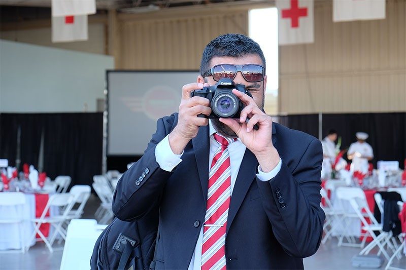 Eddie Zamora taking picture with camera.