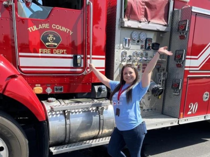reyna pearce in front of fire truck.