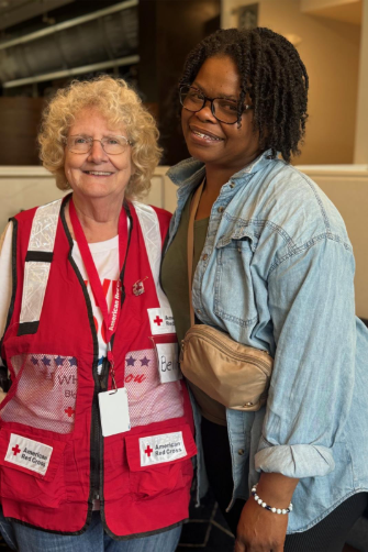 Red Cross volunteer with woman who experienced disaster