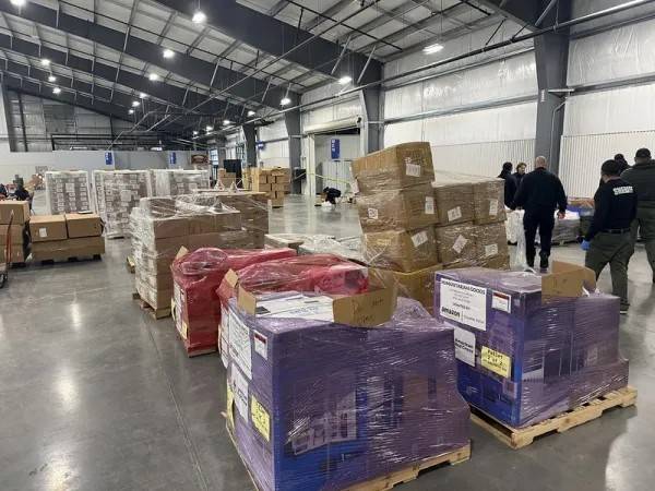 Pallets of supply items sit in Red Cross shelter