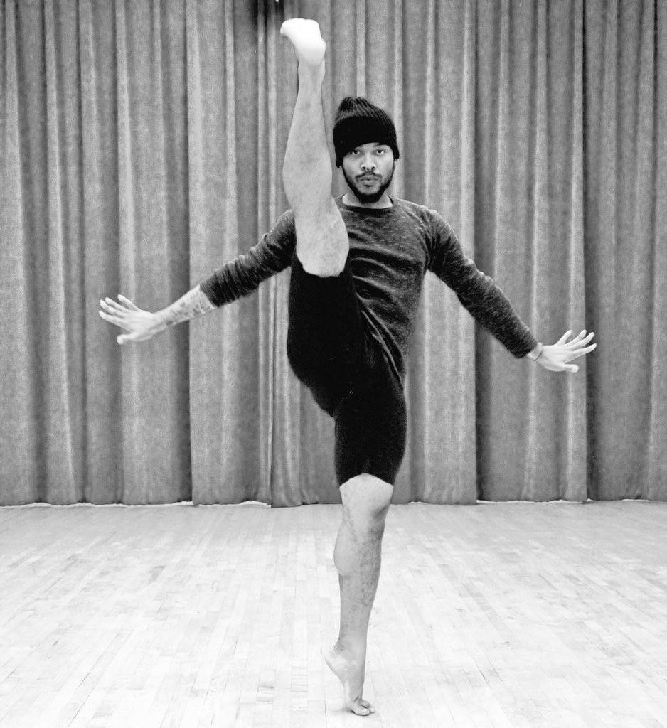 Man dancing with one leg kicked overhead