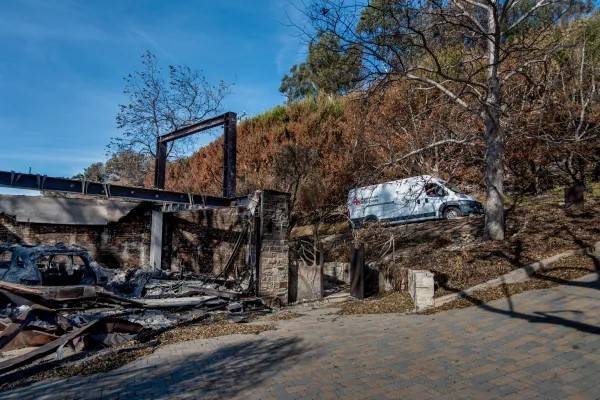 Red Cross response vehicle drives through burned community