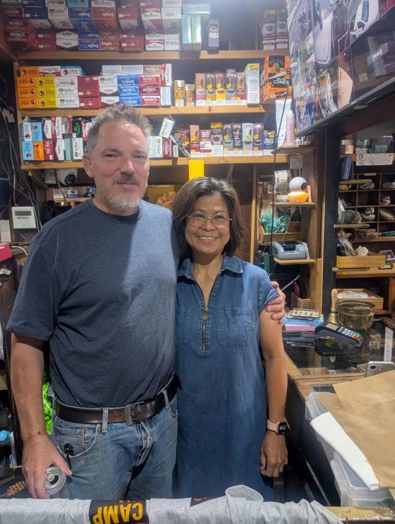 Man and woman stand in front of store shelves