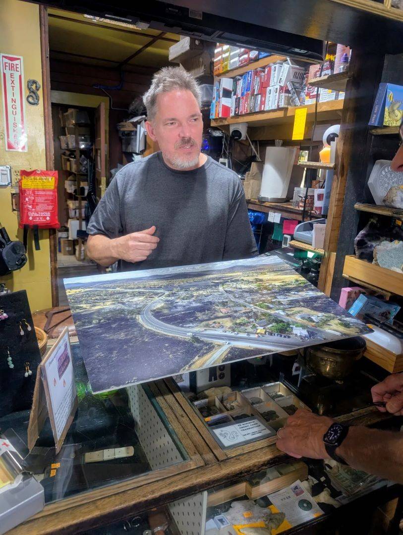 Image of man showing large photo print