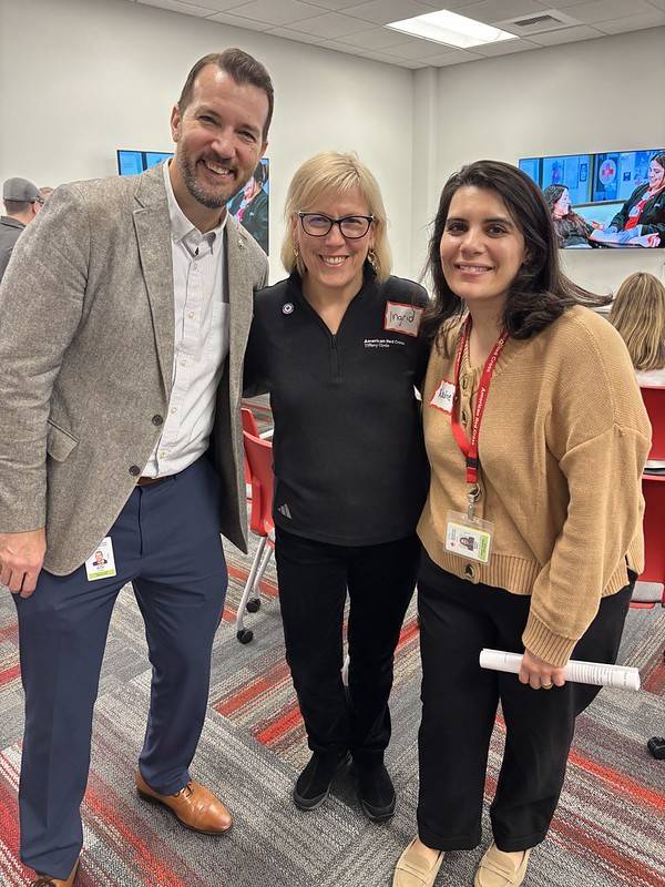 Group of three pose for photo