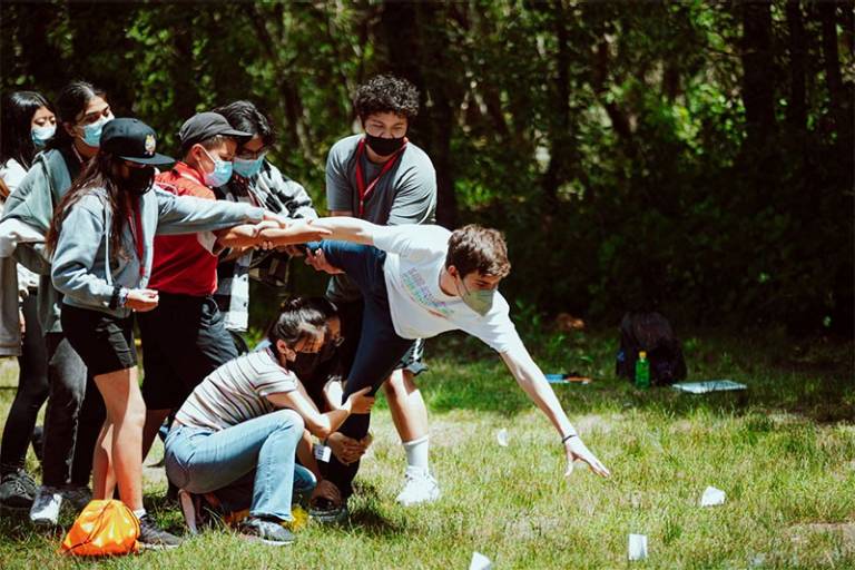 Youth at camp playing game on grass