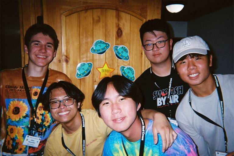 5 young men smiling for camera