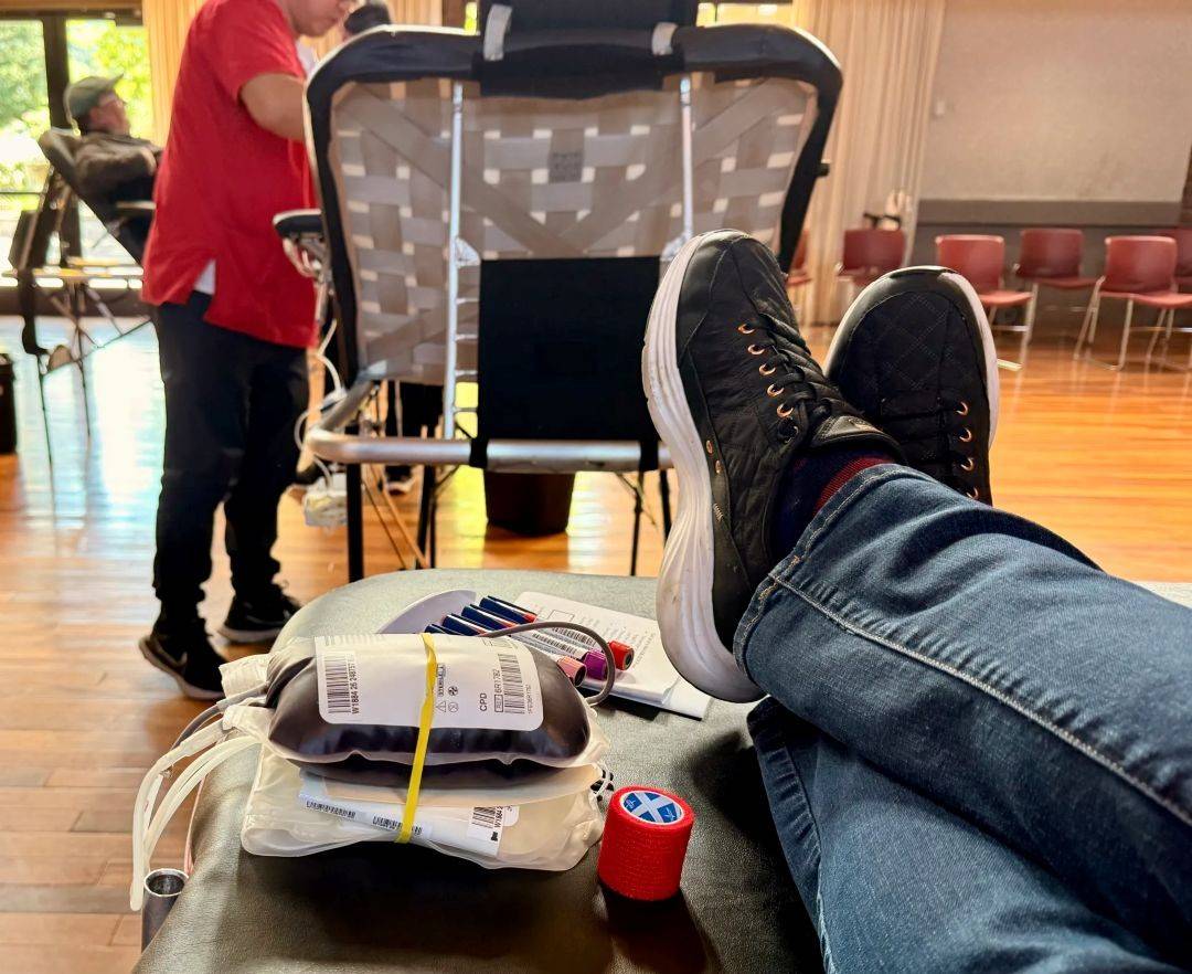 Donated blood bag sits at the bottom of a Red Cross donation chair