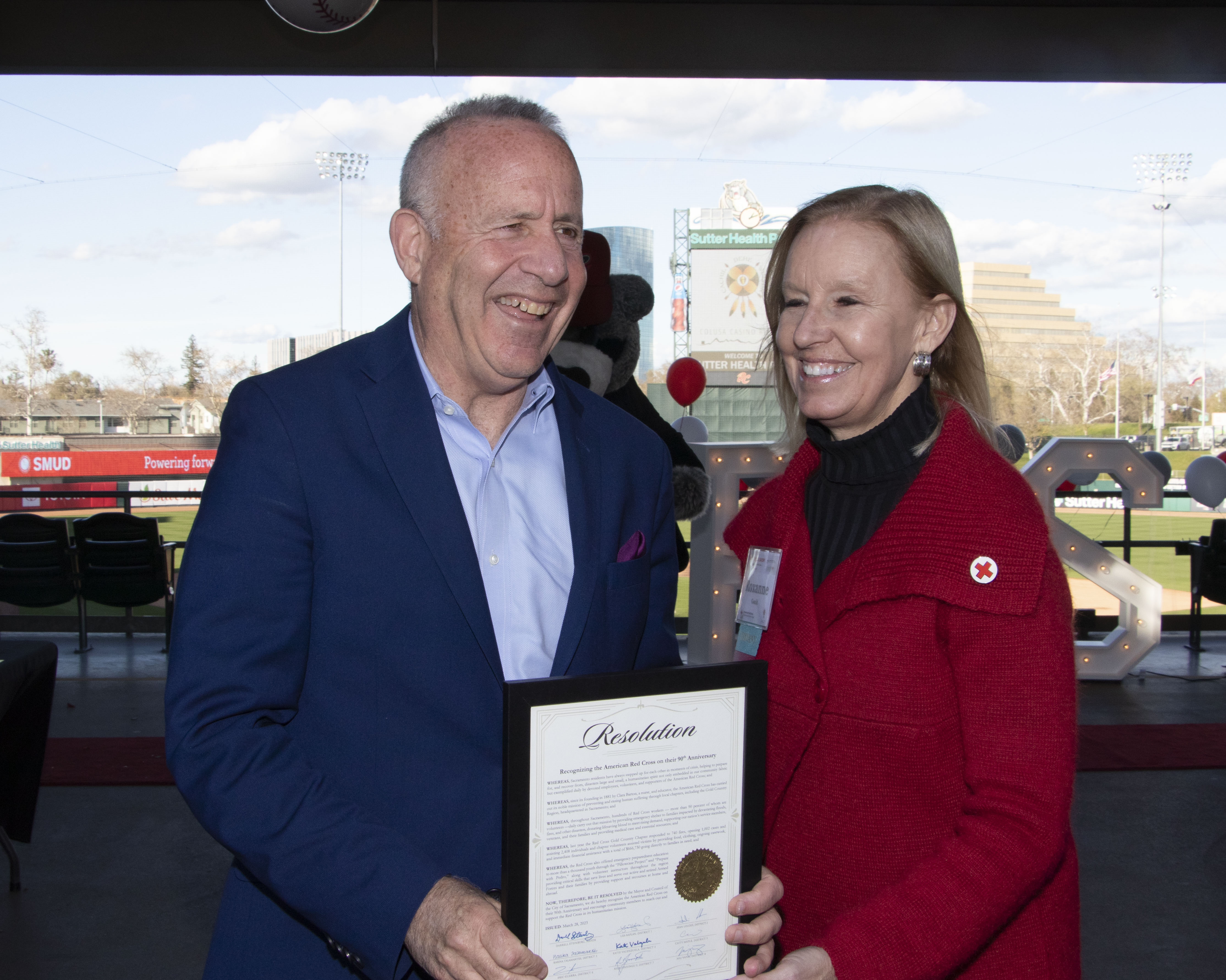 man and woman holding resolution certificate 