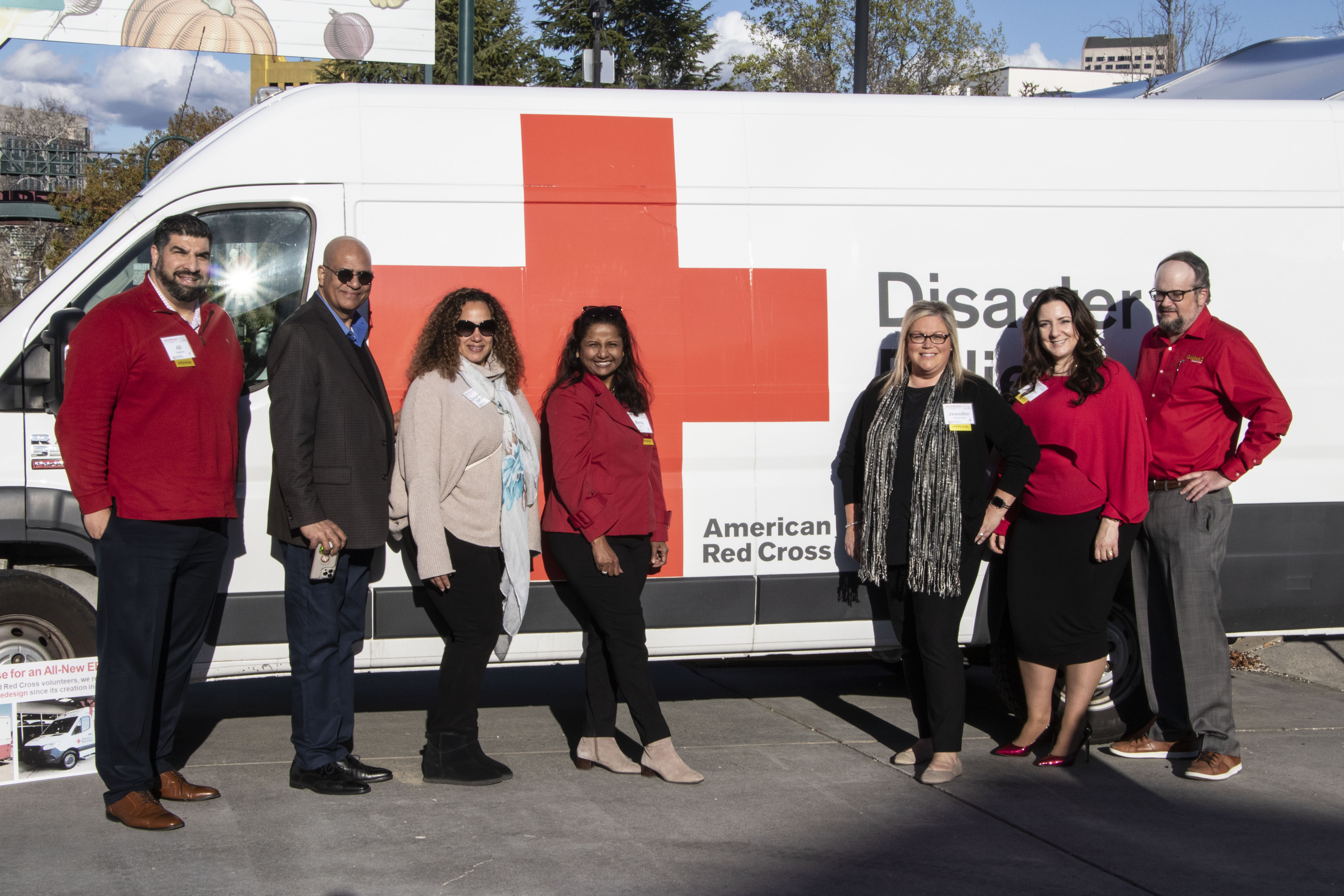 group of people in front of emergency response vehicle
