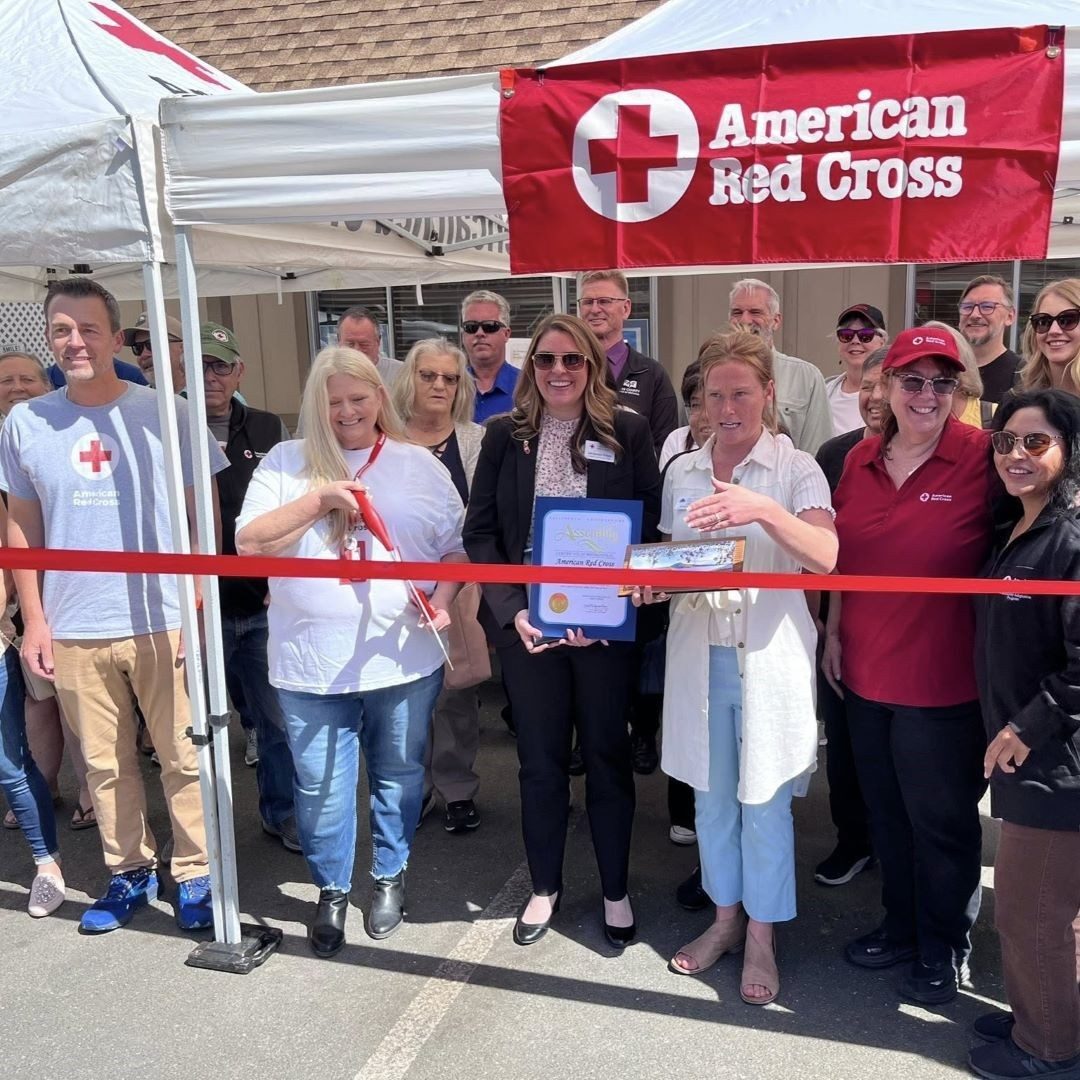 group of people cut ribbon 
