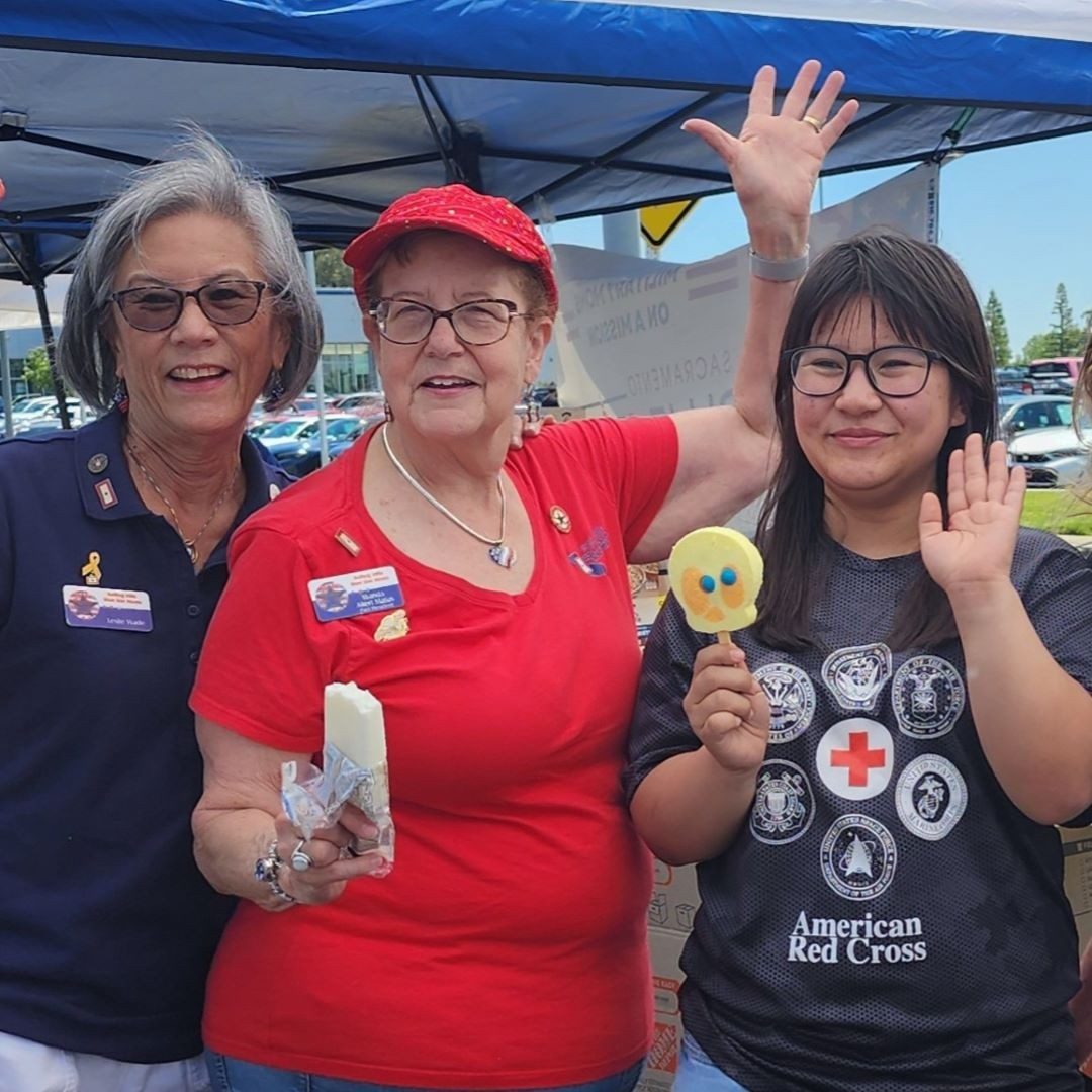 three women holding goodies and smiling