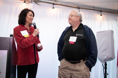 A person holding a microphone and a person talking