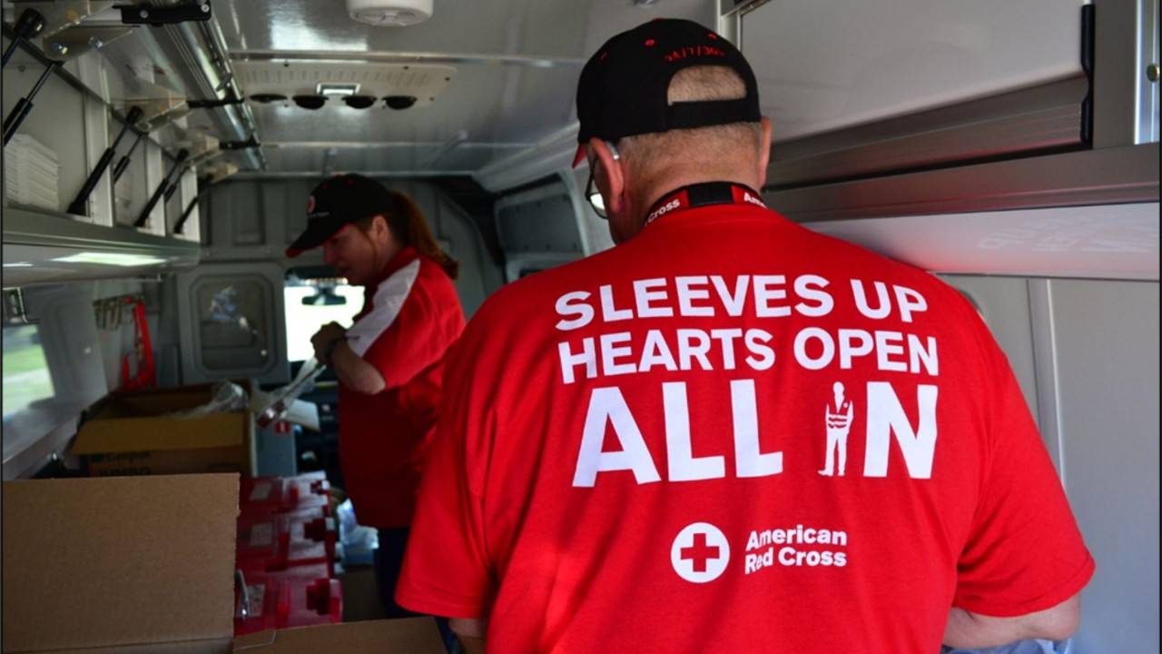 volunteer with red cross shirt in truck