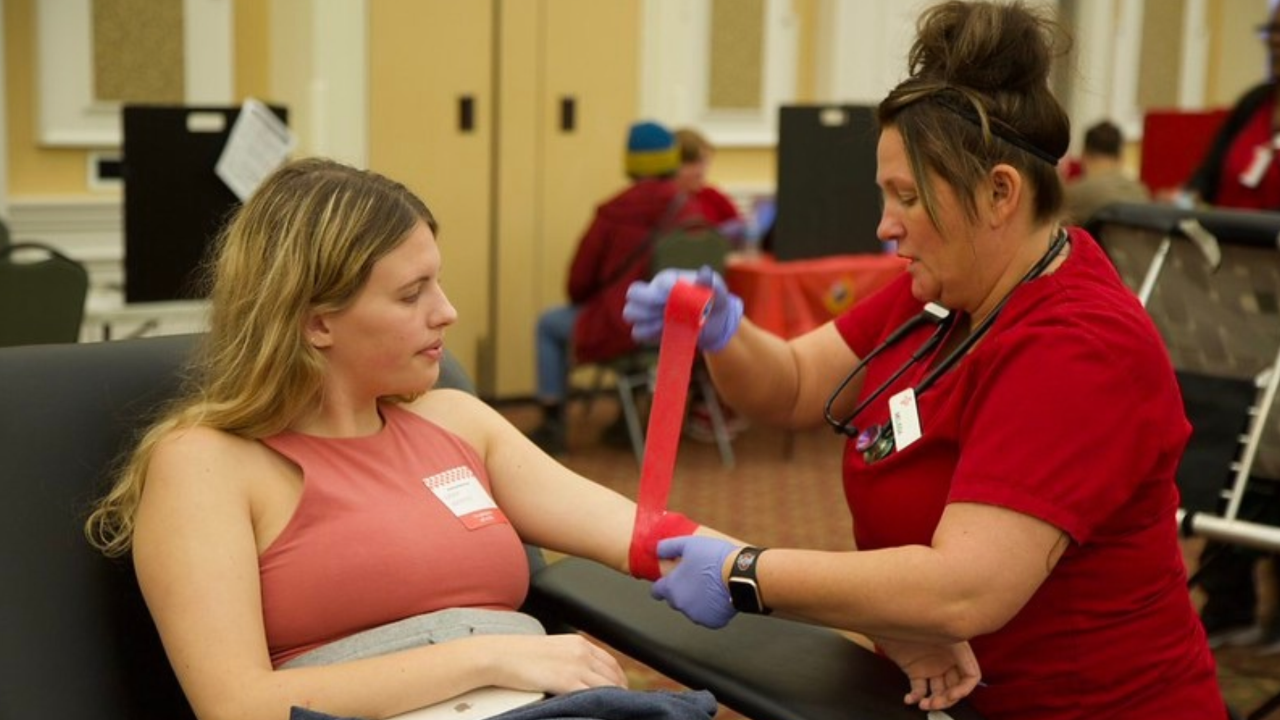 Red Cross blood donor, donating blood
