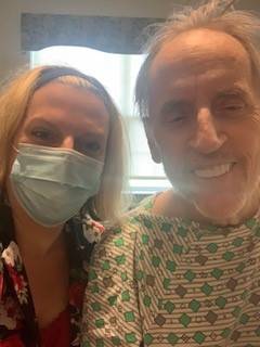 Sarah in the hospital with her father wearing a mask.
